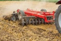 Tractor cultivating wheat stubble field, crop residue