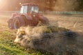 Tractor cultivator plows the land, prepares for crops. dust on field