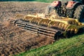 Tractor cultivator plows the land, prepares for crops. dust on field