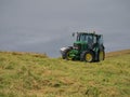 A tractor cutting grass during silage operations Royalty Free Stock Photo