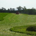 Tractor cutting hay field in New York State