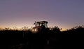 A tractor at dawn moves through the crops on a Victorian farm.