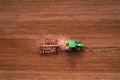 Tractor with disc cultivator Vaderstad on cultivating field. Agricultural tractor with Plough on Plowed and cultivation field.