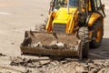 Bulldozer Dismantles Asphalt at Work