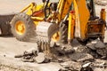 Bulldozer Dismantles Asphalt at Work