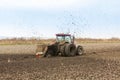 Tractor with double wheeled ditcher digging drainage canal.