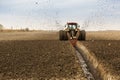 Tractor with double wheeled ditcher digging drainage canal