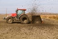 Tractor with double wheeled ditcher digging drainage canal