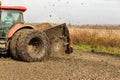 Tractor with double wheeled ditcher digging drainage canal