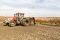 Tractor with double wheeled ditcher digging drainage canal