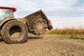 Tractor with double wheeled ditcher digging drainage canal