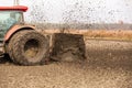 Tractor with double wheeled ditcher digging drainage canal