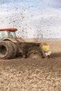 Tractor with double wheeled ditcher digging drainage canal