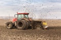 Tractor with double wheeled ditcher digging drainage canal