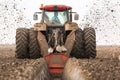 Tractor with double wheeled ditcher digging drainage canal