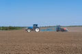 The tractor drives across the field and cultivates the land.