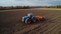 Tractor drives across large field for sowing seeds, drone view created with generative AI technology Royalty Free Stock Photo