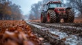 A tractor driving down a muddy road in the fall Royalty Free Stock Photo