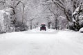 Tractor driving down a snow covered road Royalty Free Stock Photo