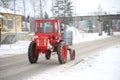 Tractor driving down a snow covered road Royalty Free Stock Photo