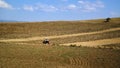 Tractor driving field and blue sky