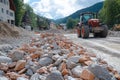 Tractor driving on a muddy road construction site, with piles of rocks and debris Royalty Free Stock Photo