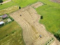 Tractor driving over rice field on harvest