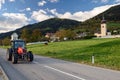 Tractor driving on the road in the alpine village Obermillstatt, Austria Royalty Free Stock Photo