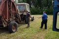 Tractor Farm Equipment Mechanics inspect in process of making ha