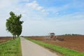 Tractor on a farm field working with a disc harrow Royalty Free Stock Photo