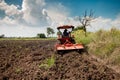 Tractor for farming workingon field and sky background