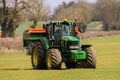 Tractor and fertilizer spreader in field