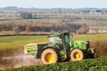 Tractor and fertilizer spreader in field