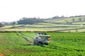 Tractor and fertilizer spreader in field