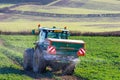 Tractor and fertilizer spreader in field