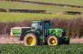 Tractor and fertilizer spreader in field