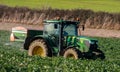 Tractor and fertilizer spreader in field