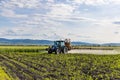 Tractor fertilizes crops