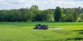 Tractor fertilizes a field in spring