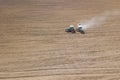 Tractor fertilizing field, Aerial View. Tractor spreading artificial fertilizers.
