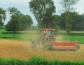 A tractor fertilizing a field