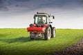 Tractor fertilizing in field