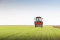 Tractor fertilizing in field