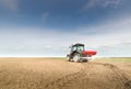 Tractor fertilizing in field