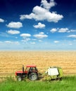 Tractor in the field in a blue sky day Royalty Free Stock Photo