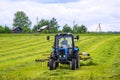 Tractor on the field. Hay making Royalty Free Stock Photo