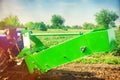 Tractor in the field with a plow for digging potatoes harvesting, seasonal work, fresh vegetables, agro-culture, farming, close-up Royalty Free Stock Photo