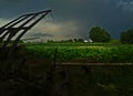 Tractor in a field before a thunderstorm and heavy clouds Royalty Free Stock Photo