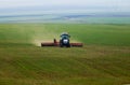 Tractor in a green corn-field