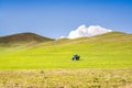 Tractor on green meadow with blue sky in Turkey, near Agri